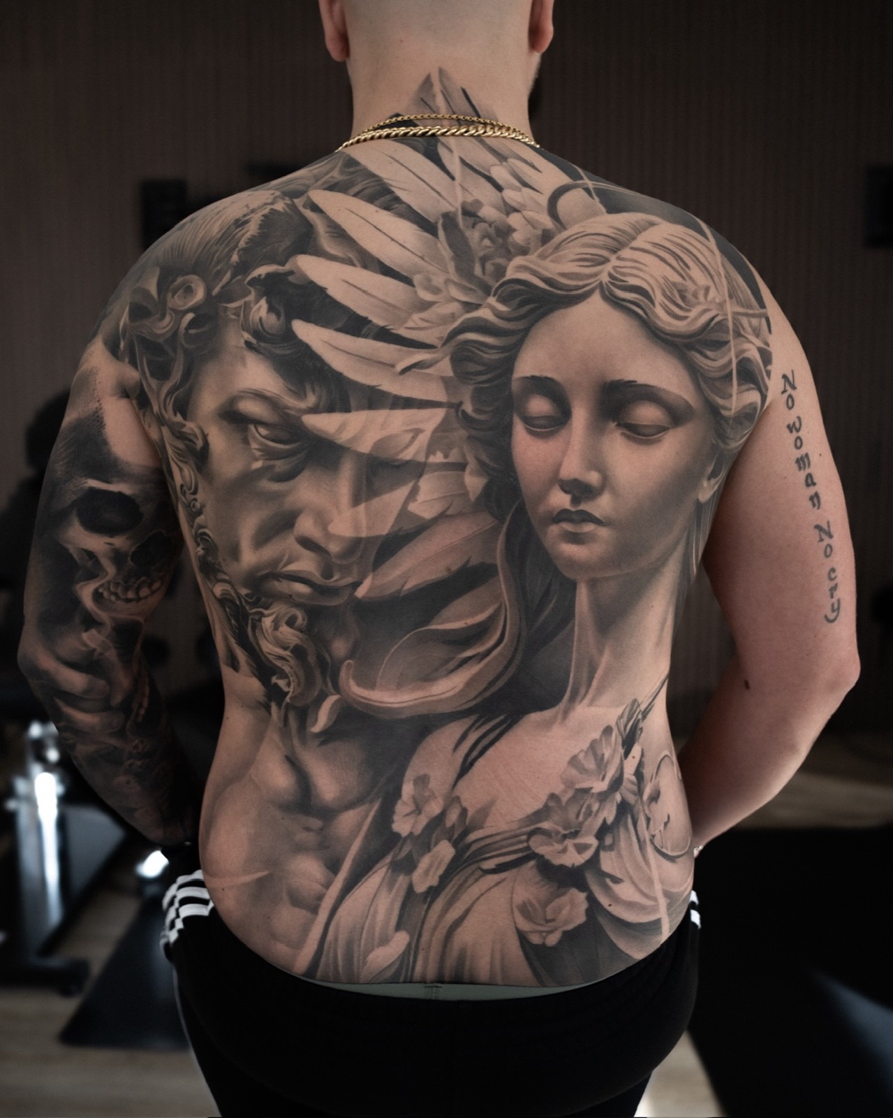 Classical black and grey back piece with two sculptural figures