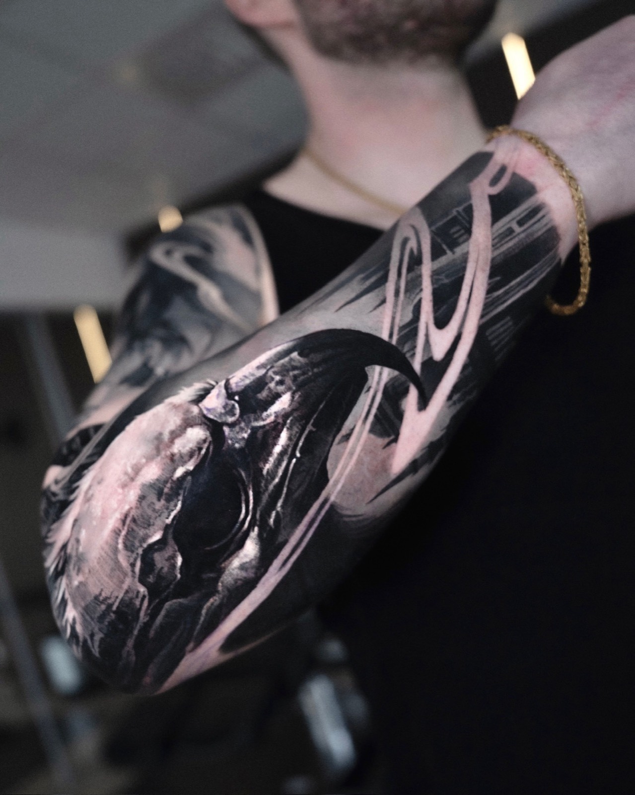Black and grey raven tattoo with abstract brushwork