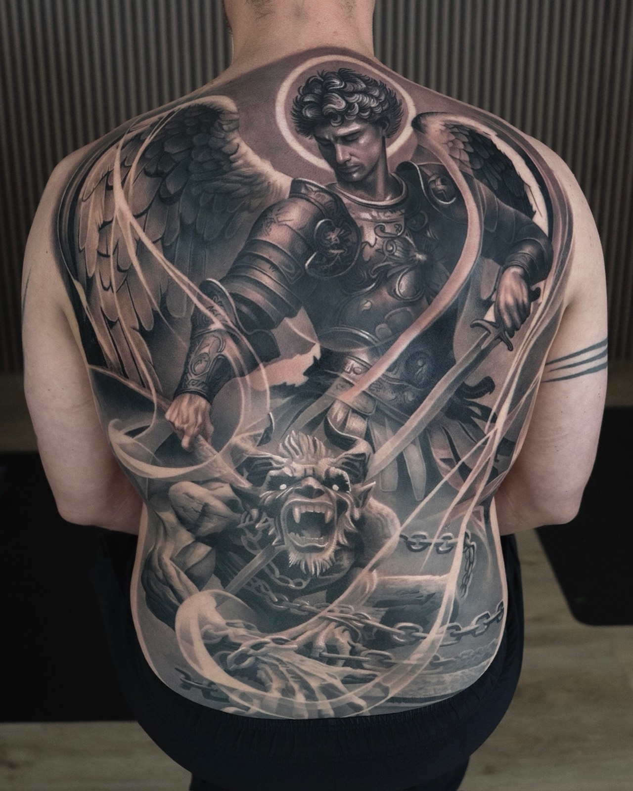 Large-scale black and grey Saint Michael back tattoo